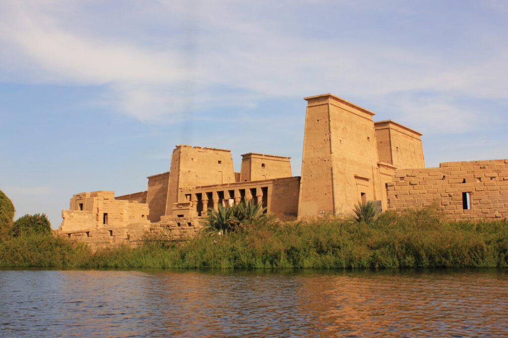 View of the Philae Temple in Aswan from a serene felucca ride on the Nile River